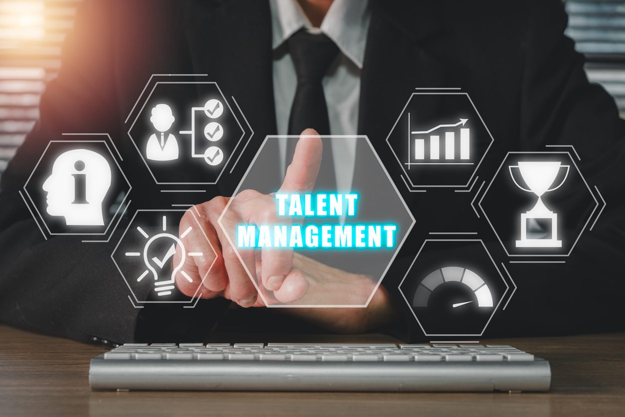 Talent management concept, Businessman hand touching talent management icon on virtual screen.