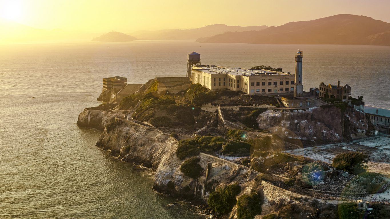 Aerial view of prison building on Alcatraz Island during sunset, San Francisco Bay, California, USA.