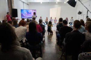 Speakers make a presentation at a corporate business conference. Unrecognizable people in the audience of the conference hall. Business and Entrepreneurship Event. High quality photo