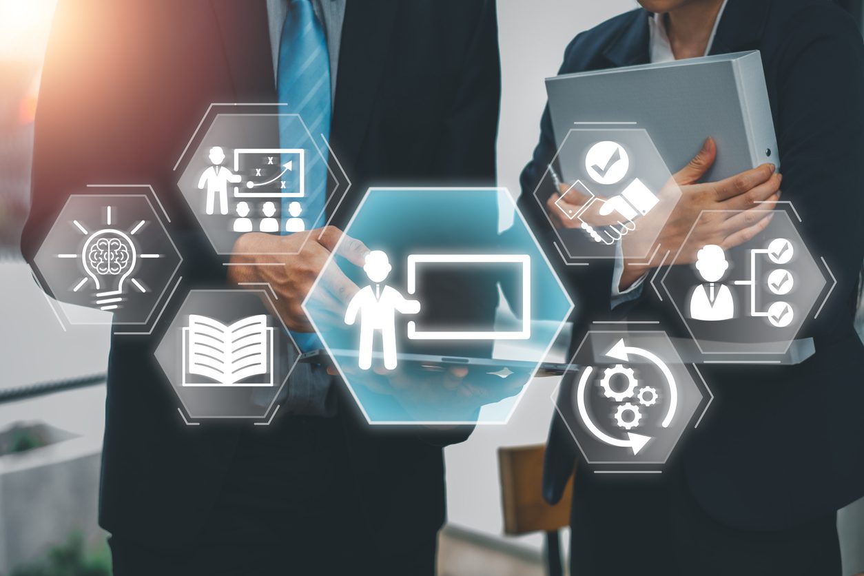 Business professionals collaborating on capacity building with digital training icons and technology