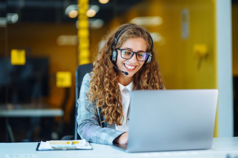 Call center agent with headset working on support hotline in modern office. Video conference. online training.