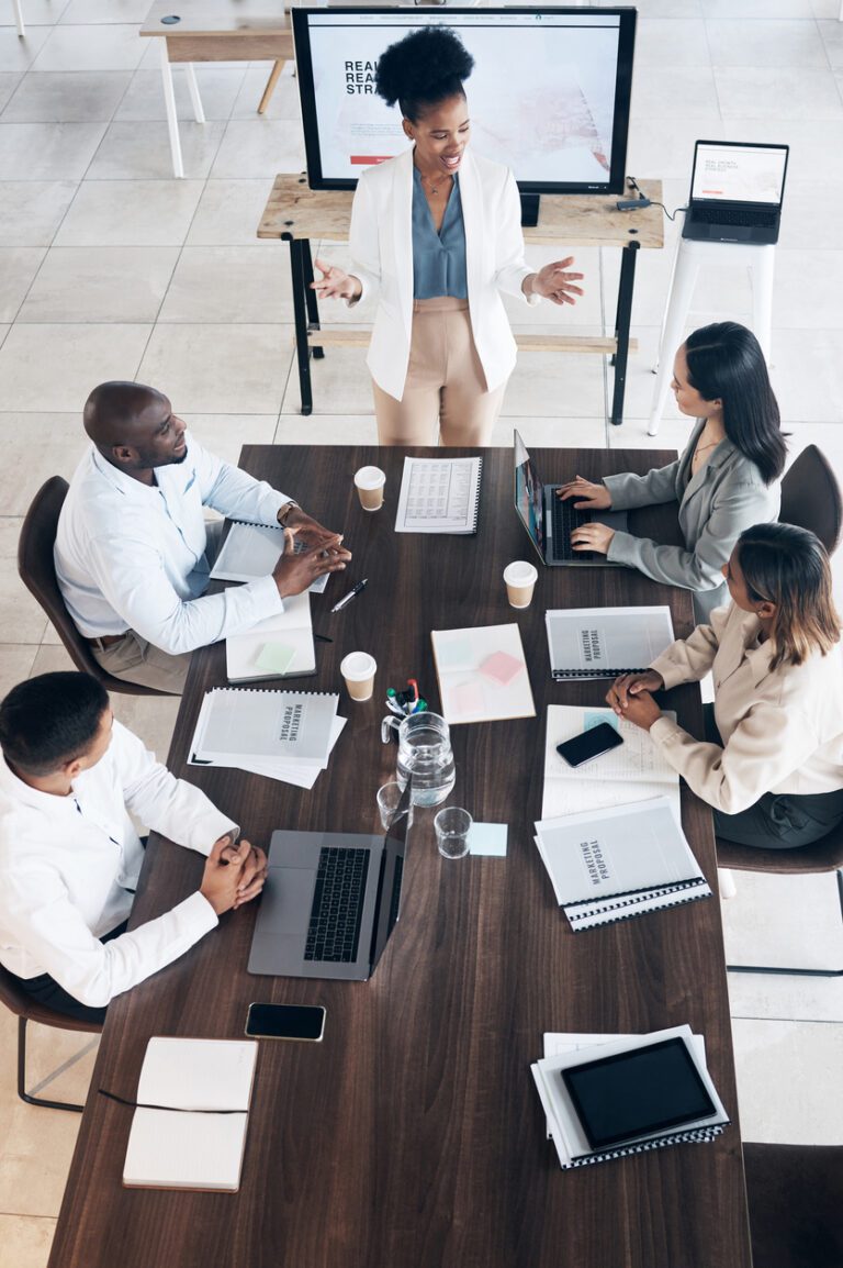 Business meeting, presentation and people above for conference, seminar or workshop in corporate training. Professional black woman, manager or speaker speaking to clients, employees or company staff